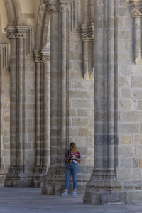 Full length of woman standing in front of building