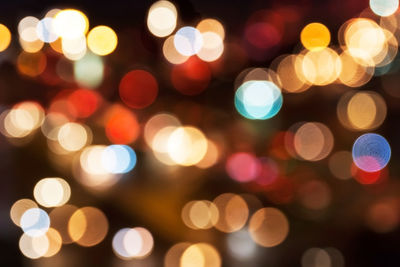 Defocused image of illuminated christmas lights at night