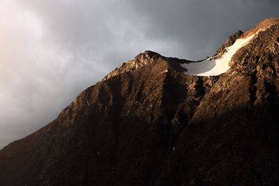 Low angle view of mountain range against sky