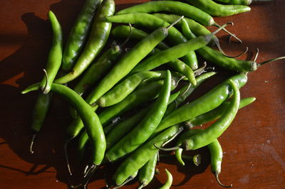 High angle view of green chili peppers on table