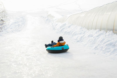 People in boat on snow