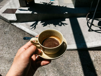 Person holding coffee cup