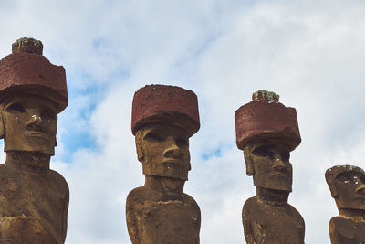 Statue of ancient moai against sky on easter island