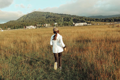 Full length of man standing on field against sky