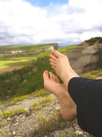 Low section of woman resting on mountain