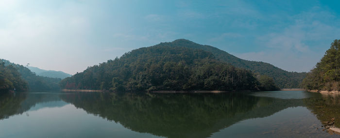 Scenic view of lake and mountains against sky