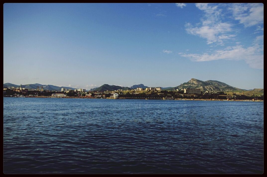 transfer print, water, mountain, auto post production filter, waterfront, sea, blue, scenics, tranquil scene, sky, tranquility, rippled, mountain range, beauty in nature, clear sky, nature, lake, copy space, built structure, river