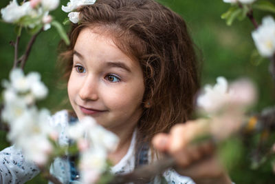 Close-up of young woman by plants