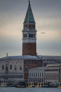 San marco bell tower and palazzo ducale against cloud sky