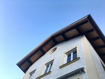 Low angle view of building against clear blue sky