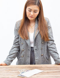 Portrait of a beautiful young woman standing on table