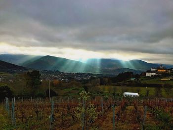 Scenic view of mountains against dramatic sky at night
