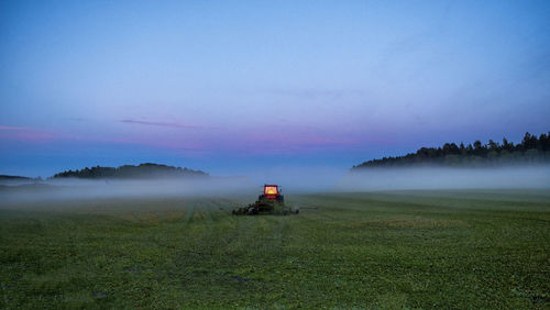 Scenic view of field against sky during foggy weather