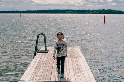 Full length of boy standing on sea shore