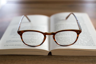 Eyeglasses on open book