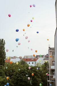 Low angle view of hot air balloons flying in sky