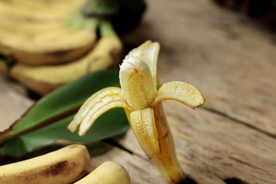 Bananas and leaves placed on old wooden floor.