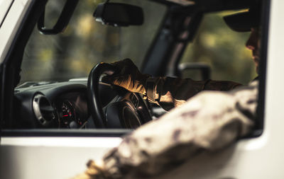 Cropped hand of man driving car