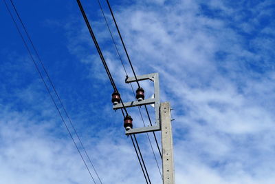 Low angle view of electricity pylon against sky
