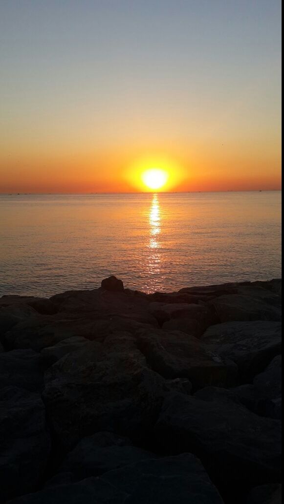 sunset, sea, sun, water, horizon over water, scenics, tranquil scene, tranquility, beauty in nature, orange color, idyllic, beach, nature, shore, reflection, rock - object, sky, clear sky, sunlight, silhouette