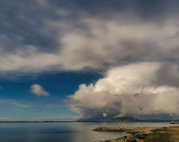 Scenic view of sea against storm clouds