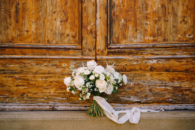 Close-up of white flowers on wooden door