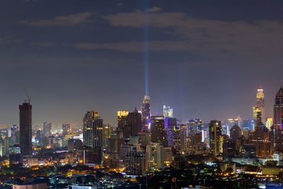 Illuminated cityscape against sky at night