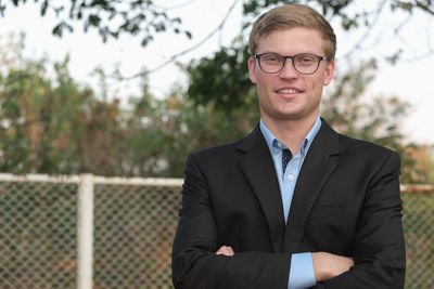 Portrait of smiling businessman standing outdoors