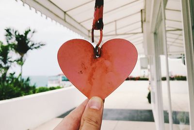 Close-up of hand holding heart shape