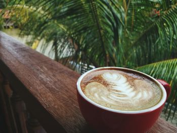 Close-up of coffee on railing