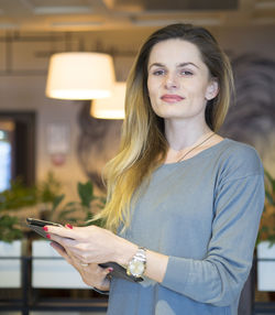 Portrait of young woman using mobile phone