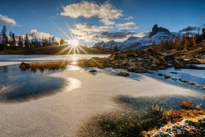 Scenic view of snowcapped mountains against sky during sunset