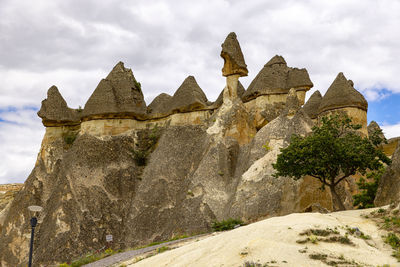 Low angle view of rock formations against sky