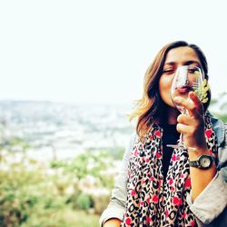 Portrait of beautiful woman drinking water
