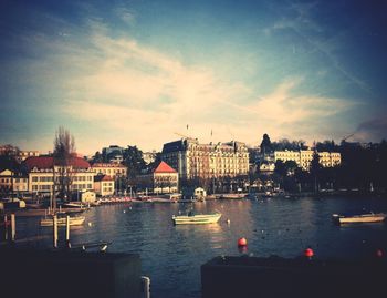 Boats in river with buildings in background