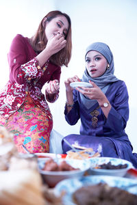 Friends and family enjoying festival meal during the eid celebration