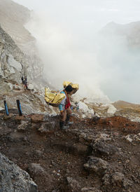 The miners carrying the sulphurs from the crater.