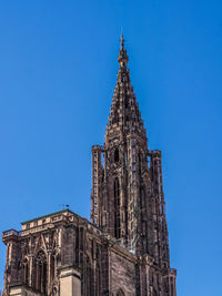 Low angle view of temple against clear blue sky