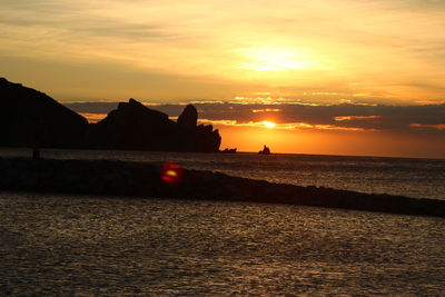 Scenic view of sea against orange sky