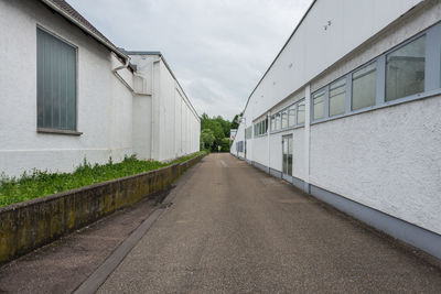 Empty road leading towards building