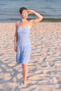 Young woman standing at beach