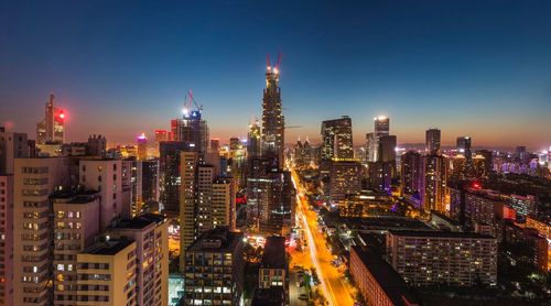 High angle view of city lit up at night