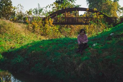 Full length of man sitting on field