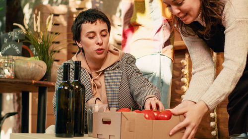 Portrait of smiling friends toasting bottles