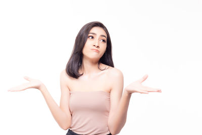 Portrait of beautiful young woman against white background