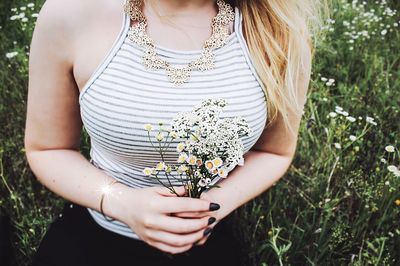 Close-up of woman holding flower