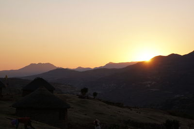 Scenic view of silhouette mountains against sky during sunset