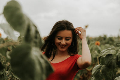 Young woman standing at sunflower farm