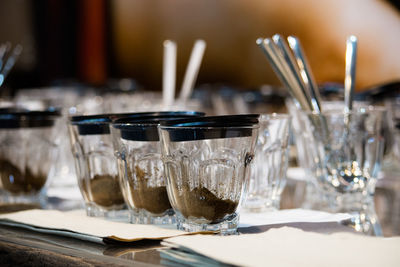 Close-up of wine glasses on table