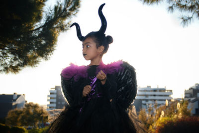 Girl with maleficent costume posing in the woods